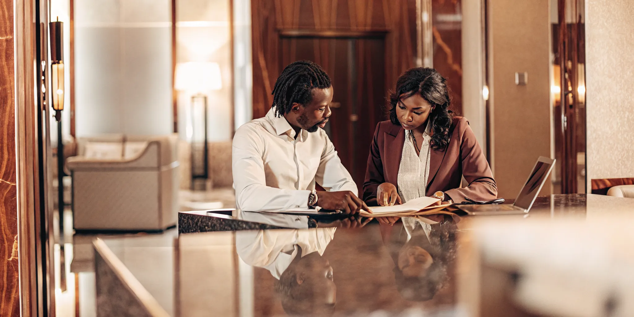 Real estate investor discussing 1031 exchange documents with a financial advisor at a luxury office